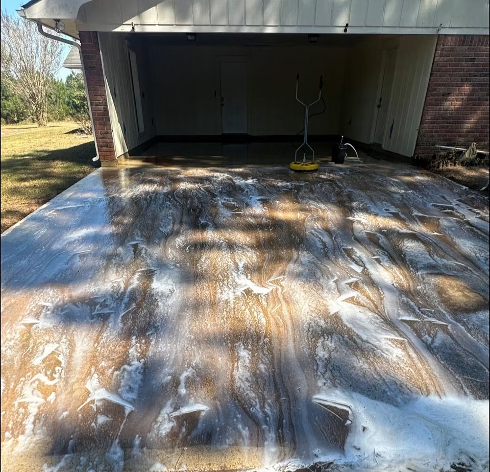 Driveway being pressure washed with soap suds
